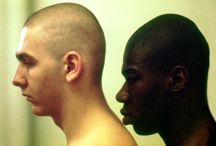 USA. Parris Island, South Carolina. 1970. Recruits are made to stand close to each other after having their heads shaved on the first day.